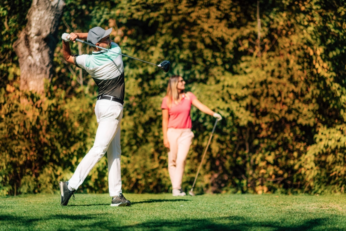 A couple enjoying a golf session.