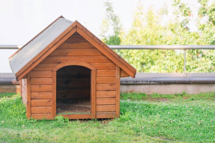 wooden dog house with a-frame roof