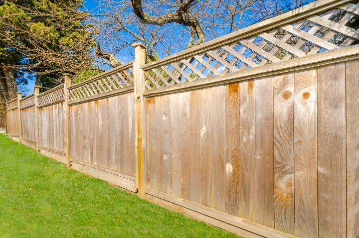 solid dog fence made of wood 