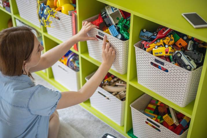 woman organising kids toys