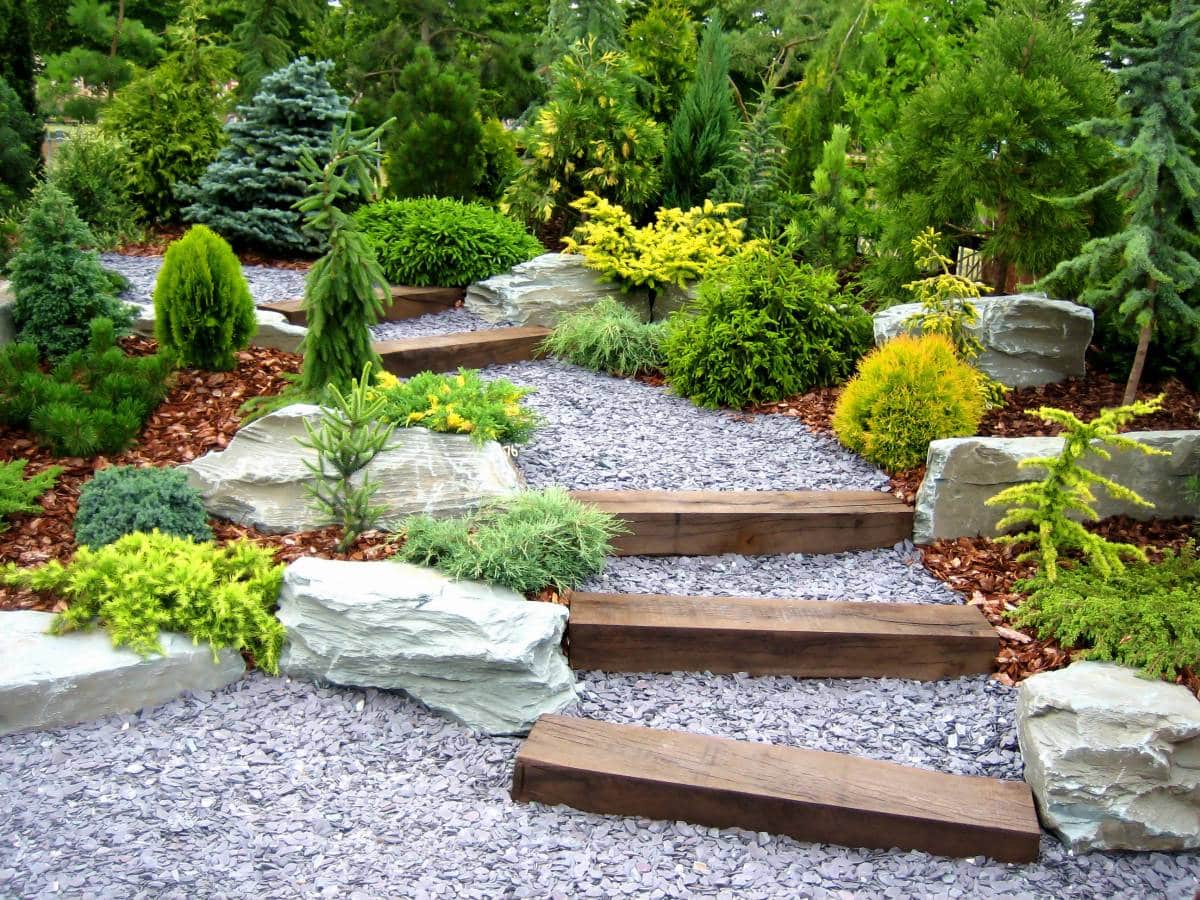 wood and gravel garden steps with plants and stones 