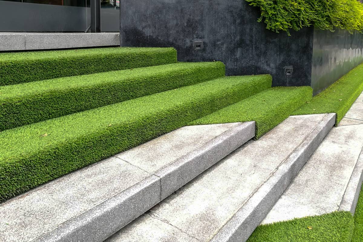 hardscape of modern stone stairway covered with artificial grass 