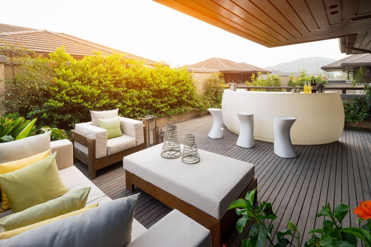 modern wooden patio with matching wooden furniture for lounging 