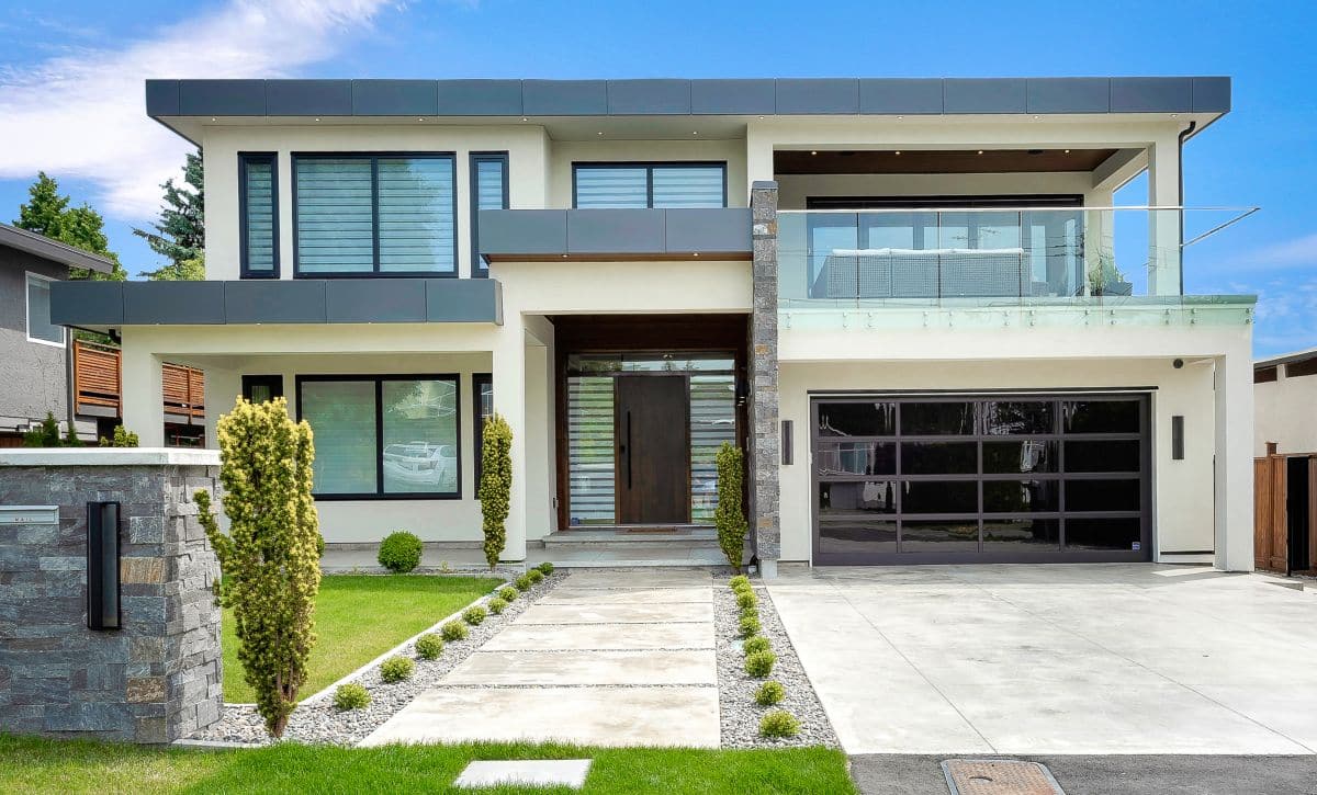 facade of a modern house, small shrubs lining the pathway entrance 