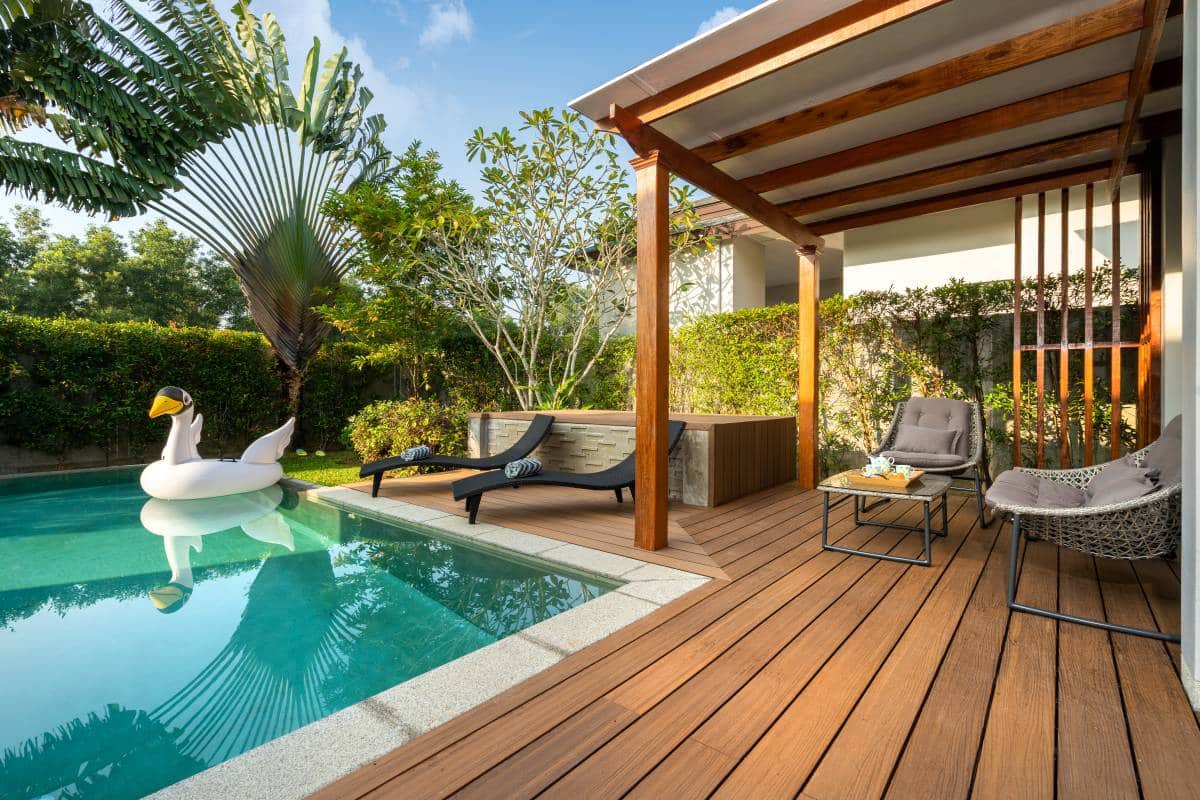 small backyard, plunge pool with pool float swan and wooden decking