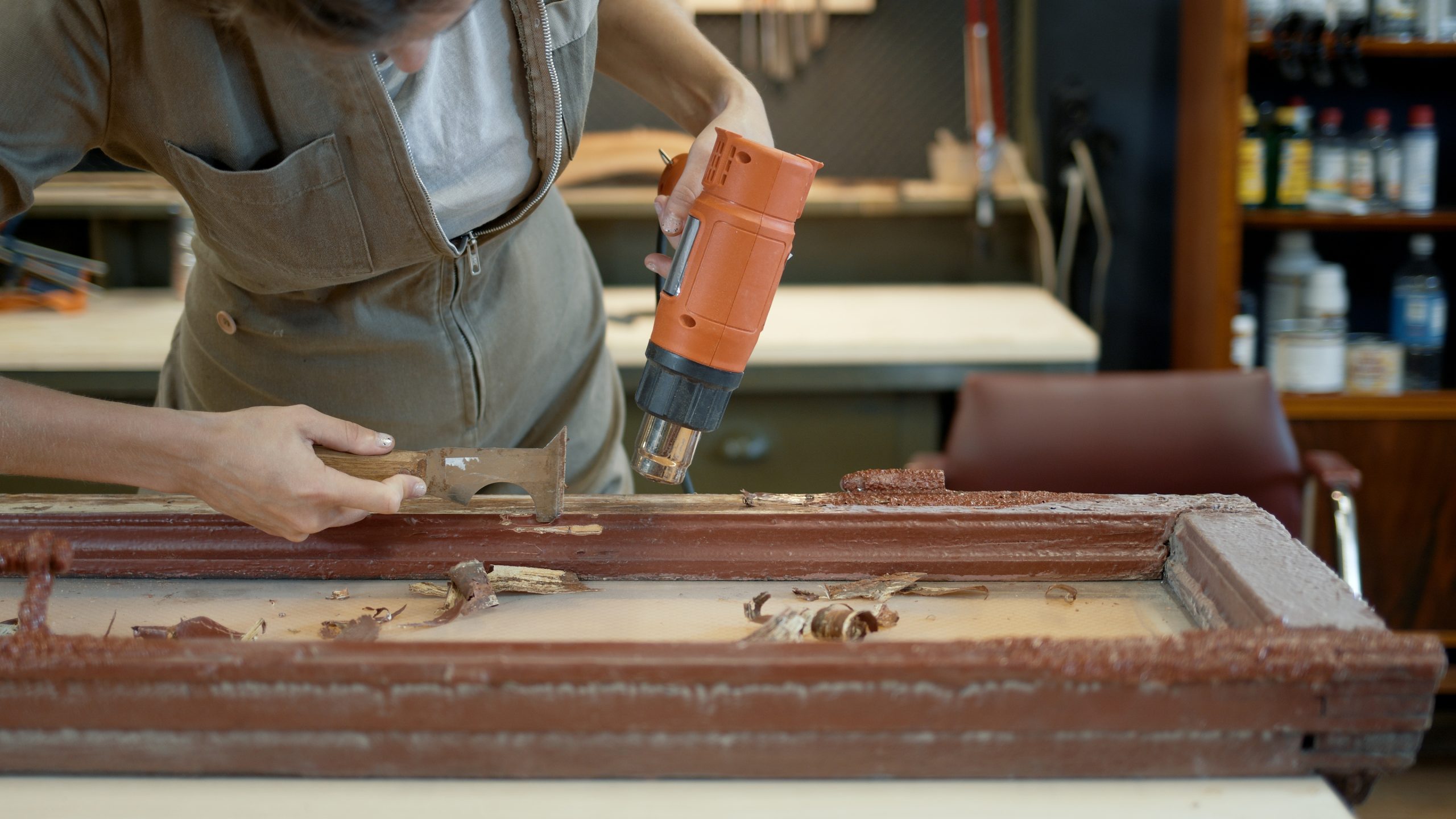 a woman restoring a flood-damaged wooden door