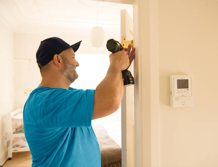 Airtasker handyman installing a door