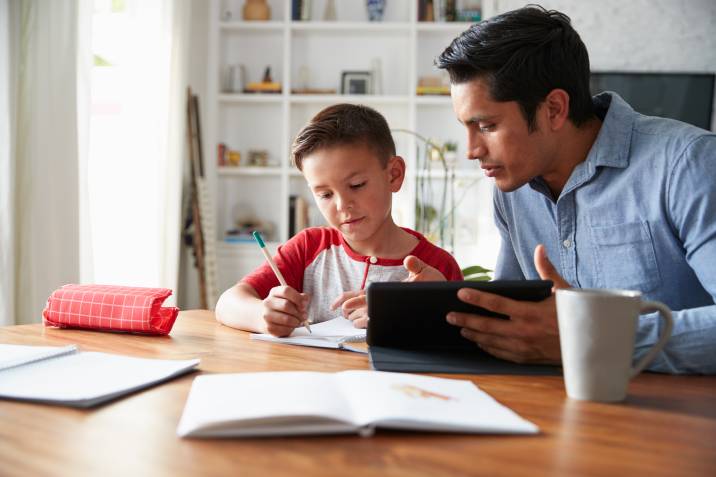 a boy working with a tutor at home