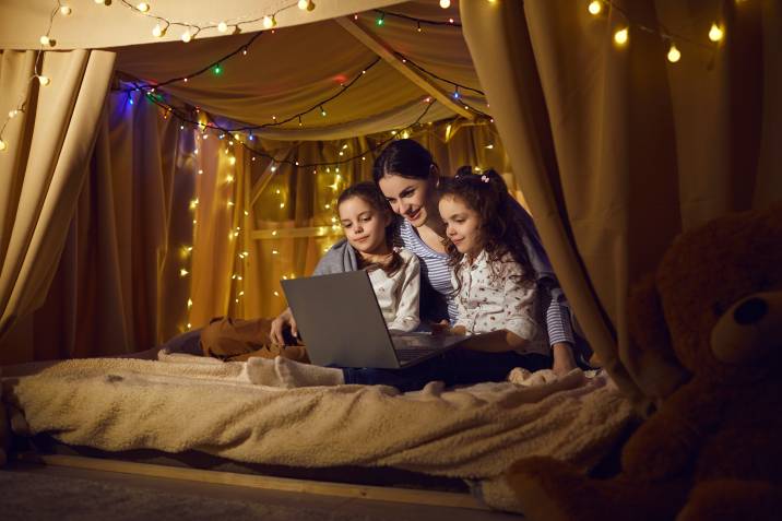 a mother with her daughters watching a movie