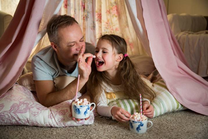 a father and daughter enjoying their hot chocolate