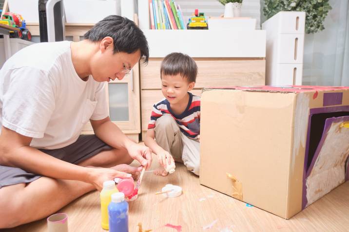 a father and son making a DIY toy together