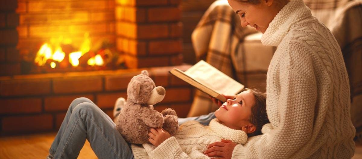 mom and daughter bonding by the fireplace