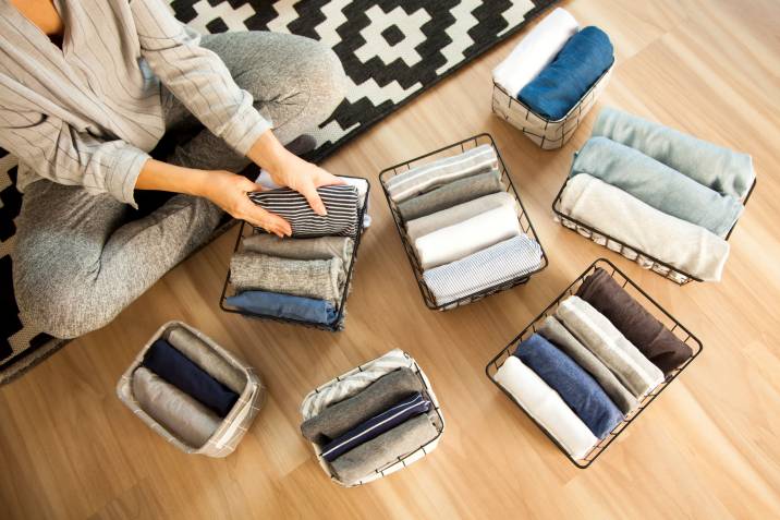 a woman folding clothes at home