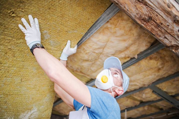 Contractor insulating house roof from inside