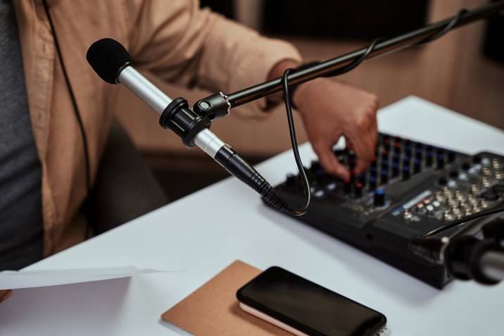 Close up of microphone of someone trying to record a podcast