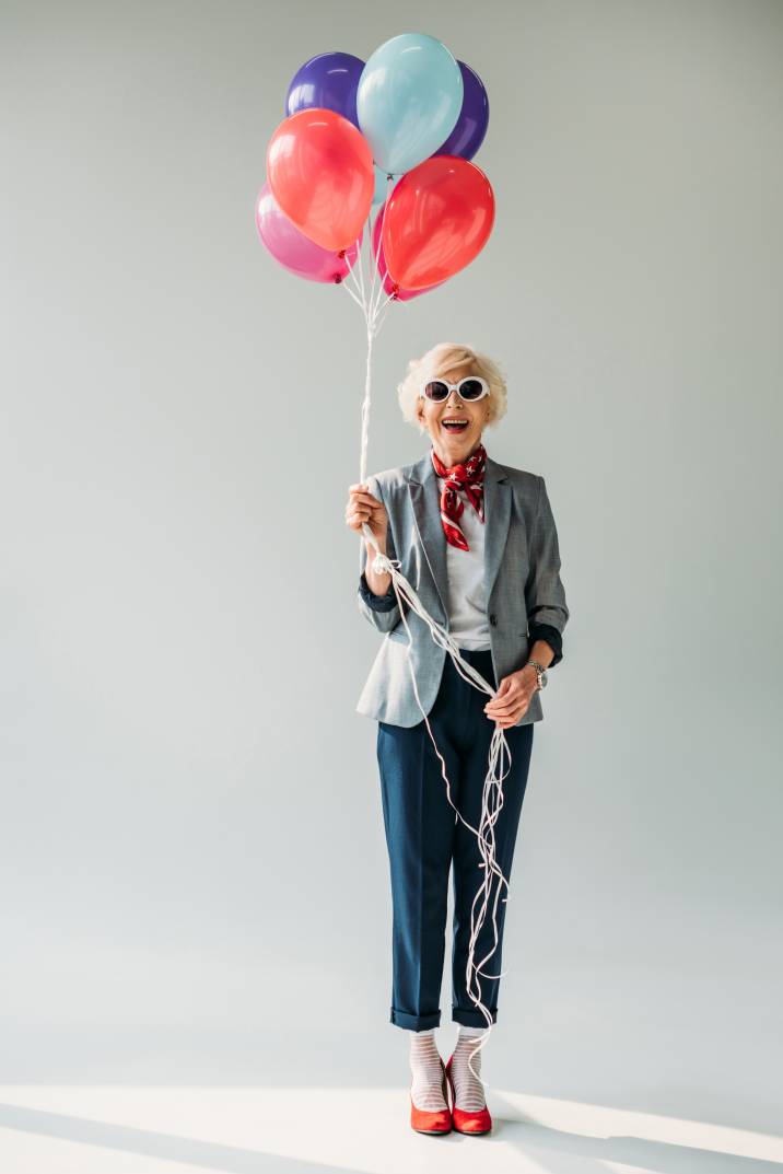 stylish senior lady modelling in sunglasses with balloons