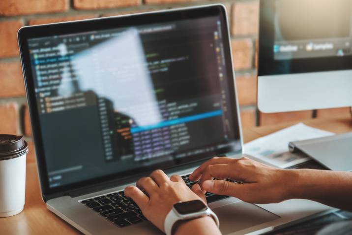 web developer writing code on his computer