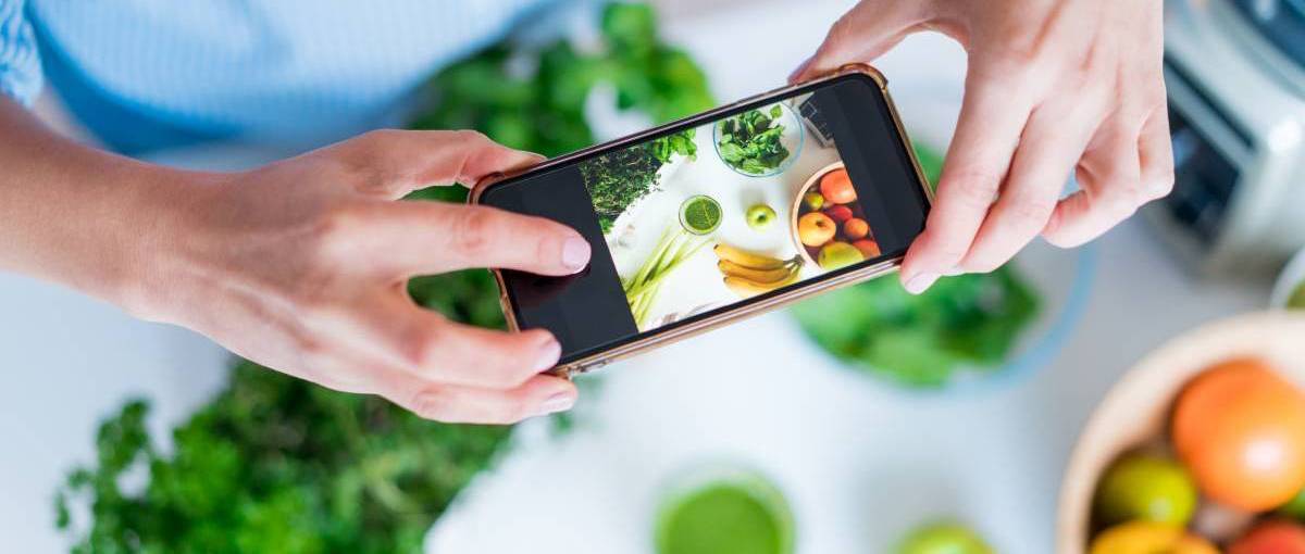 online side hustle, food photographer blogger taking photo of detox green smoothie and ingredients