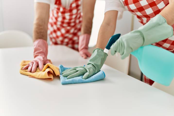 House cleaning side hustle. Young Caucasian couple cleaning table using rag and diffuser