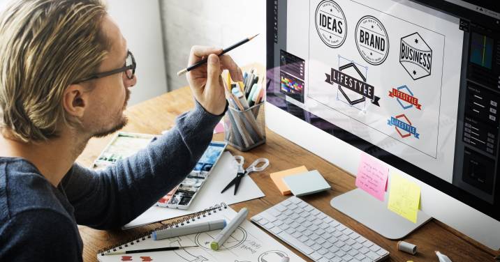 Online side hustle. Man designing logo on computer