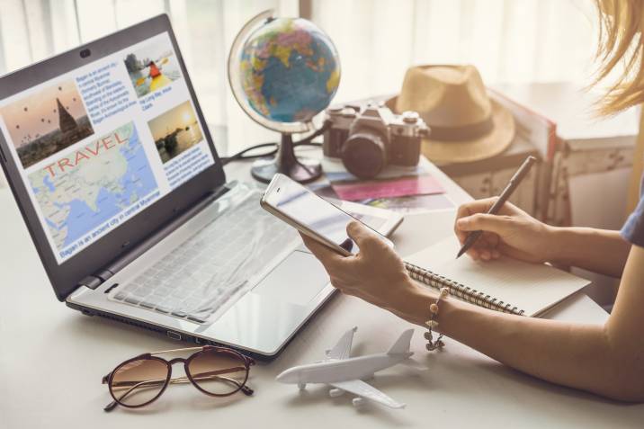 woman planning travel for client as a summer side hustle