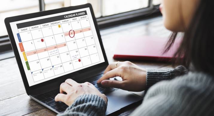 Virtual assistant updating calendar planner in laptop 