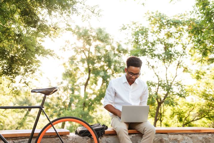 young man tutoring online using laptop to earn money over spring break