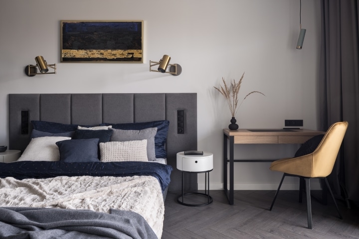 a stylish bedroom with a bedside work table