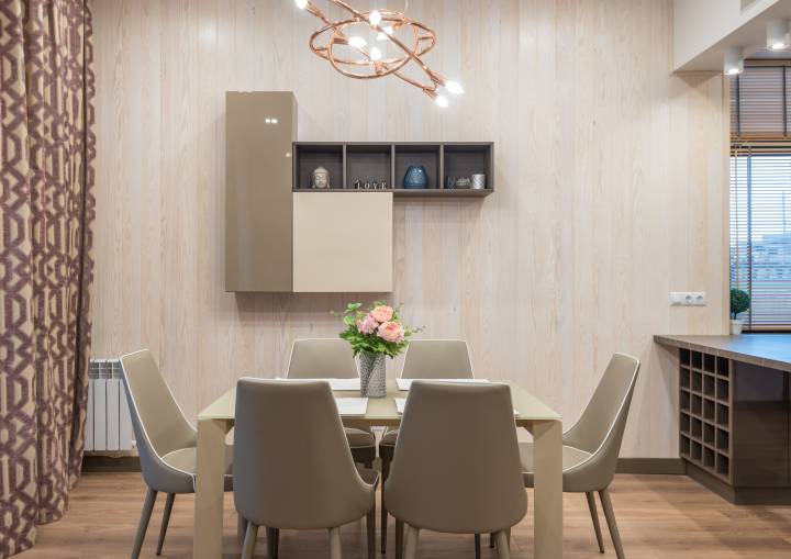 Dining area with comfortable chairs and table in modern apartment