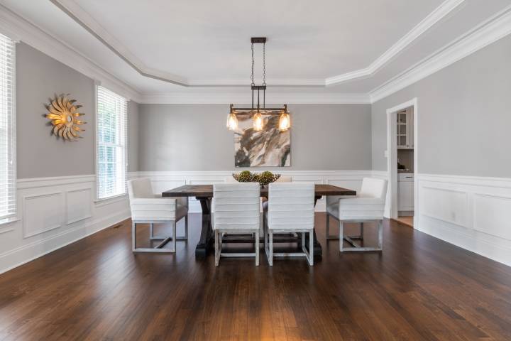 Brown wooden table with white chairs