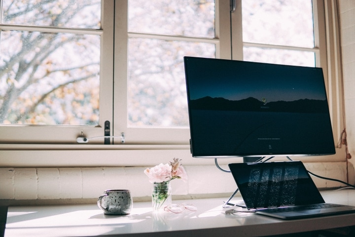 office desk with laptop and natural lighting