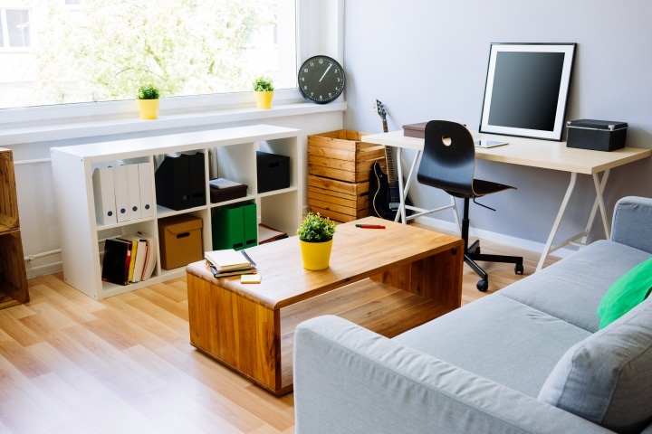 a small home office space with storage boxes for organisation