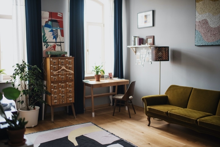 a modern home office within a living room with lots of natural lighting