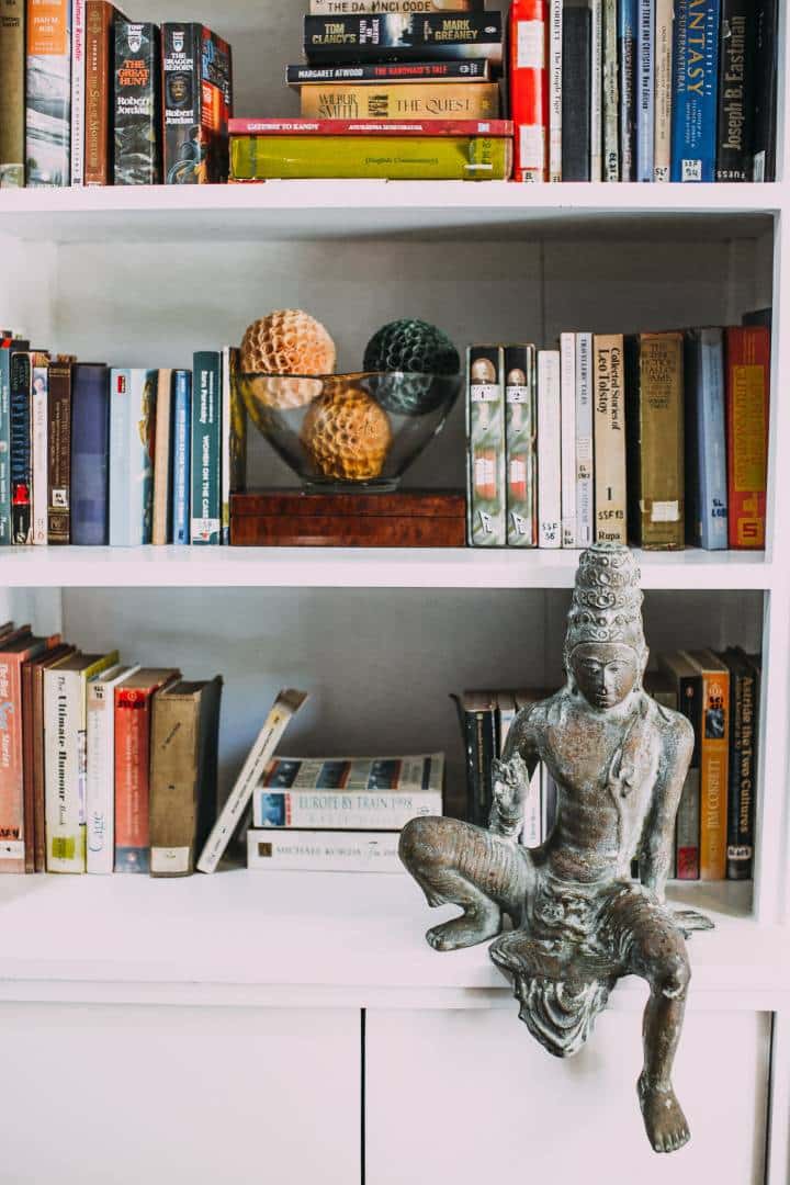 bookshelf with abstract art piece displayed