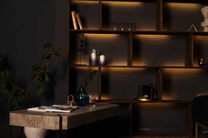 wooden bookshelf in a room with black interiors