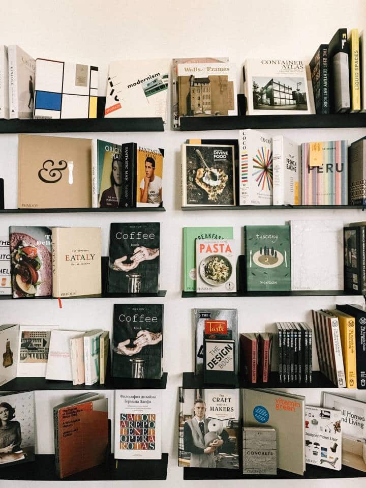 bookshelf that displays books and magazines by their cover