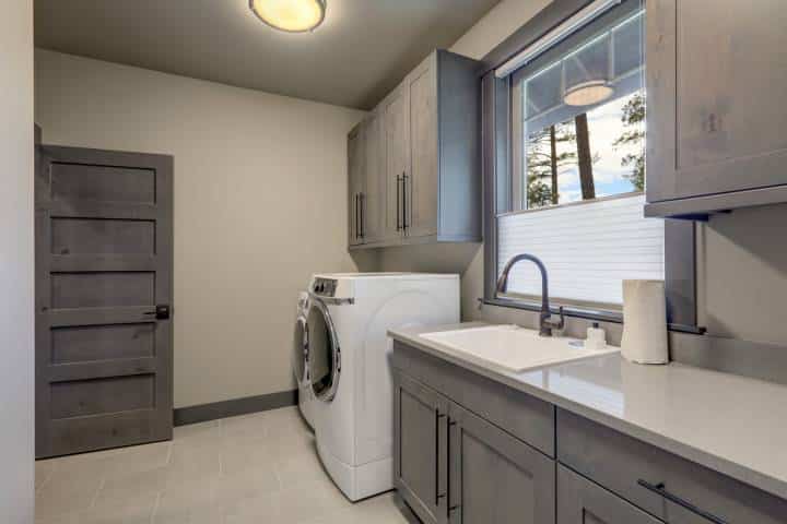 laundry room with grey doors and cabinets