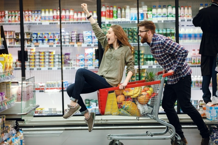 a happy couple shopping for groceries