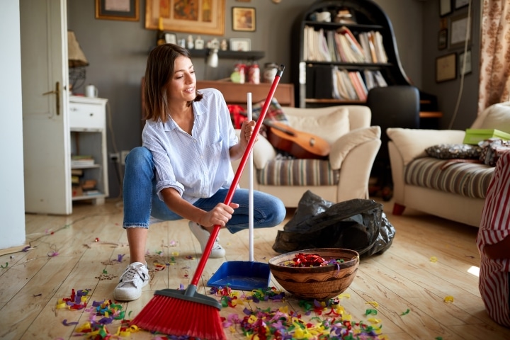a woman cleaning up after a party