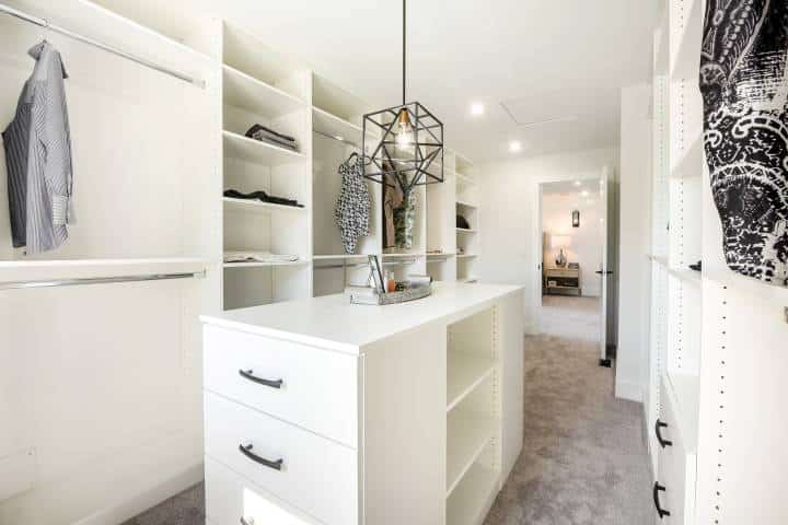 beautifully walk in closet with custom pendant lighting