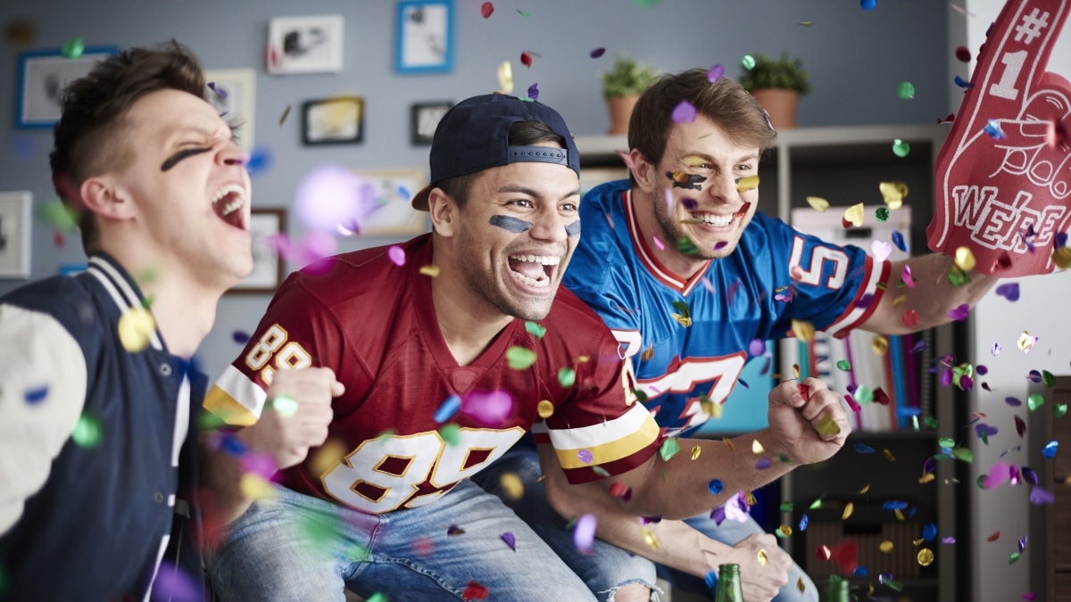 a group of friends cheering for a football game