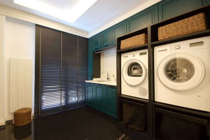 laundry area with teal green accents