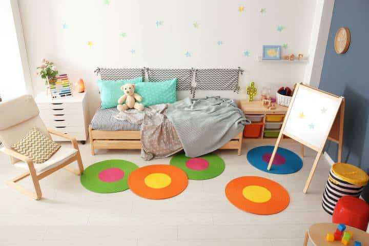 Modern child room interior with colourful rugs