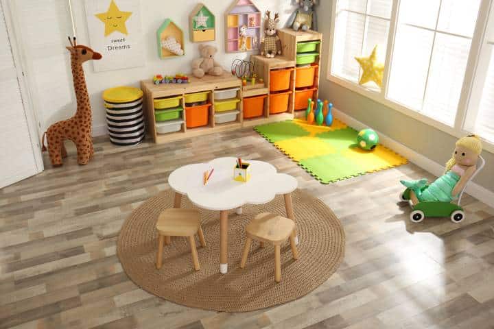 Stylish playroom interior with modern furniture and soft toys