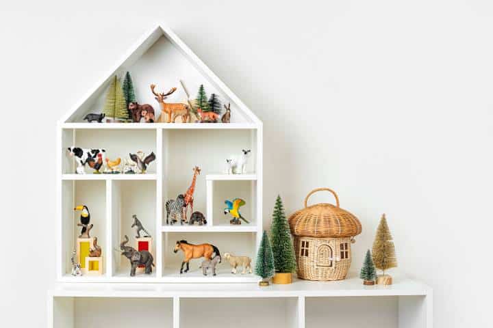Dollhouse shaped shelves with toys