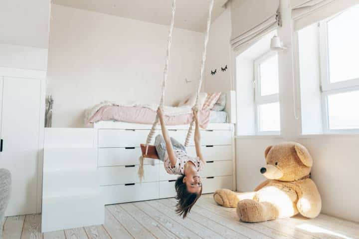 Elevated bed atop cabinets in kids playroom