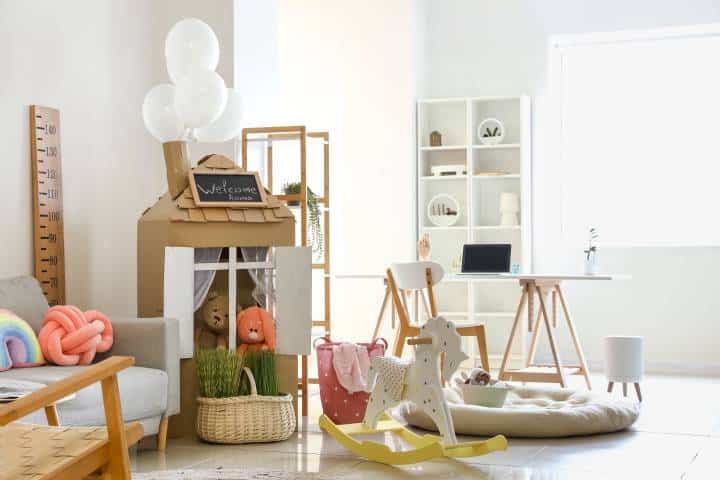 Interior of playroom with toys and cardboard house
