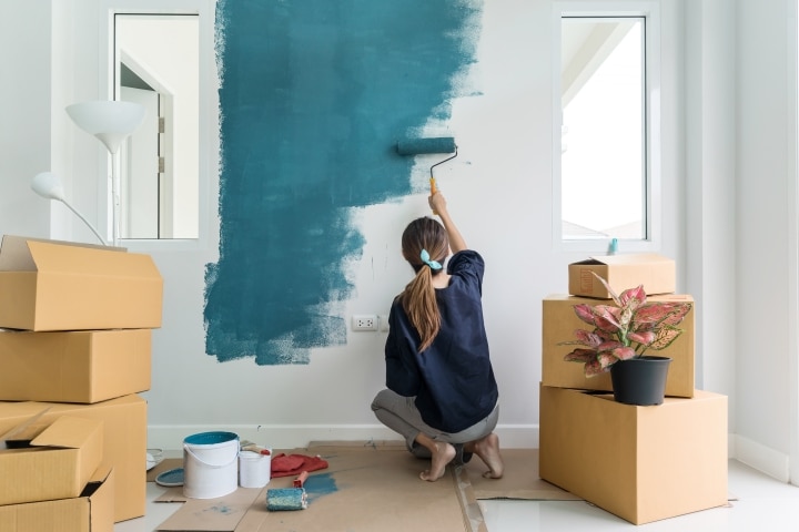 a woman repainting her interior walls