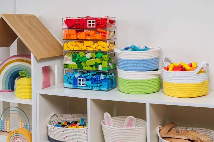 Rainbow toys in stylish baskets and plastic containers