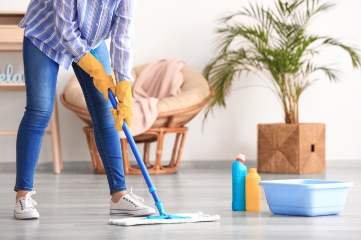 a woman mopping the floors for spring cleaning